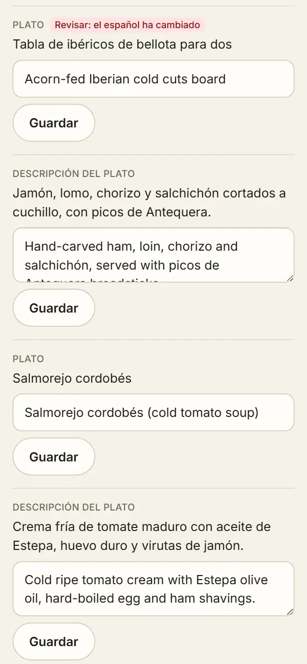 Panel de idiomas: la tabla de ibéricos de bellota para dos con la etiqueta «Revisar: el español ha cambiado» sobre su traducción Acorn-fed Iberian cold cuts board